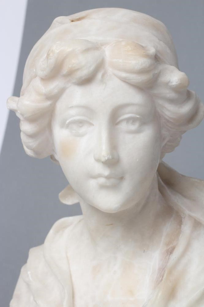 AN ALABASTER BUST OF A YOUNG WOMAN Image