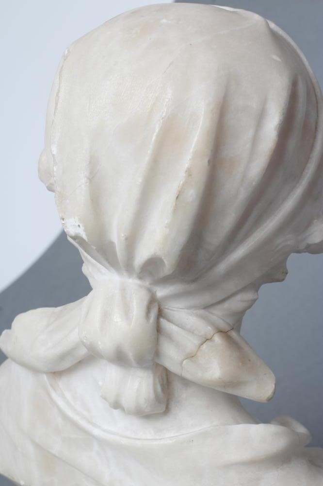 AN ALABASTER BUST OF A YOUNG WOMAN Image