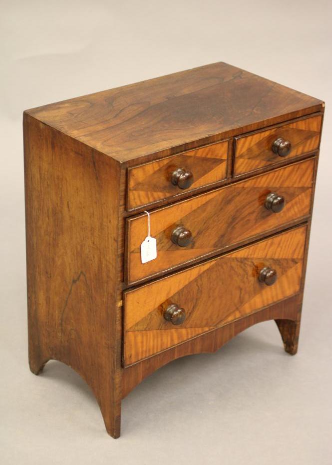 A VICTORIAN ROSEWOOD APPRENTICE CHEST of two short and three long drawers with turned wood handles Image