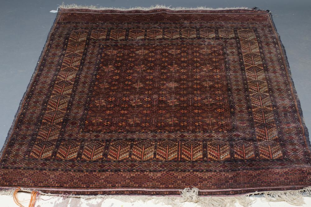AN AFGHAN RUG in muted shades of red Image