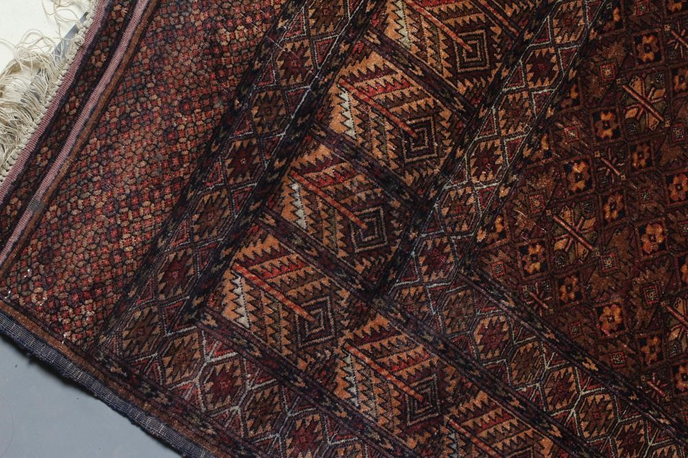AN AFGHAN RUG in muted shades of red Image
