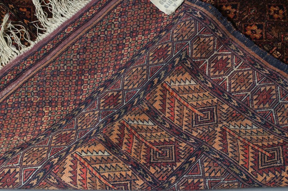 AN AFGHAN RUG in muted shades of red Image