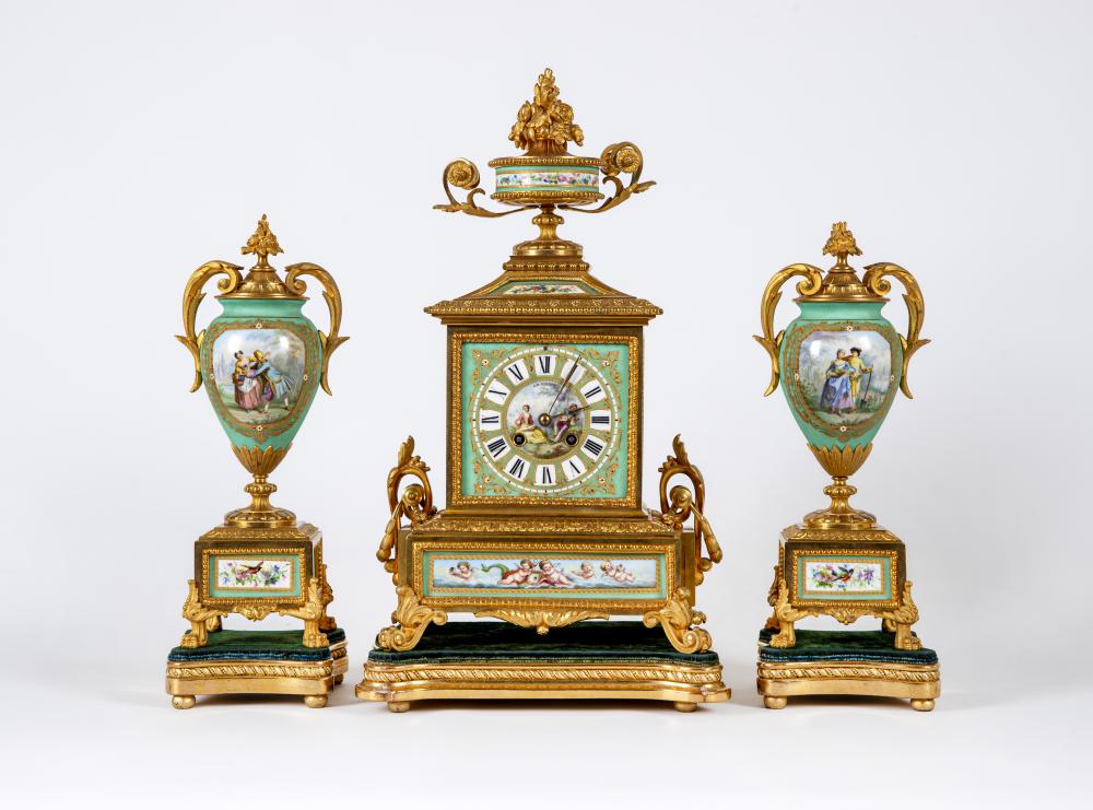 A FRENCH GILT METAL AND INSET PORCELAIN CLOCK GARNITURE Image