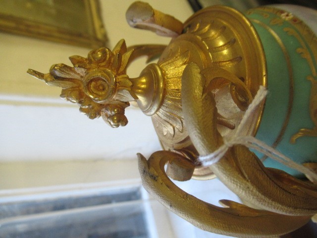 A FRENCH GILT METAL AND INSET PORCELAIN CLOCK GARNITURE Image