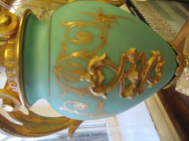 A FRENCH GILT METAL AND INSET PORCELAIN CLOCK GARNITURE Image