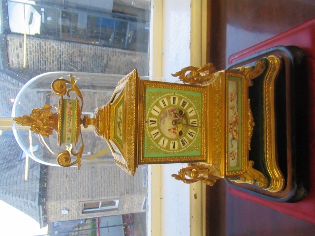 A FRENCH GILT METAL AND INSET PORCELAIN CLOCK GARNITURE Image