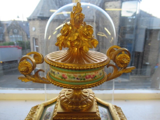 A FRENCH GILT METAL AND INSET PORCELAIN CLOCK GARNITURE Image