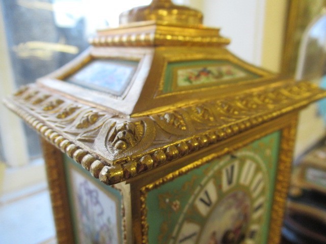 A FRENCH GILT METAL AND INSET PORCELAIN CLOCK GARNITURE Image