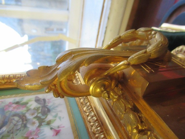 A FRENCH GILT METAL AND INSET PORCELAIN CLOCK GARNITURE Image