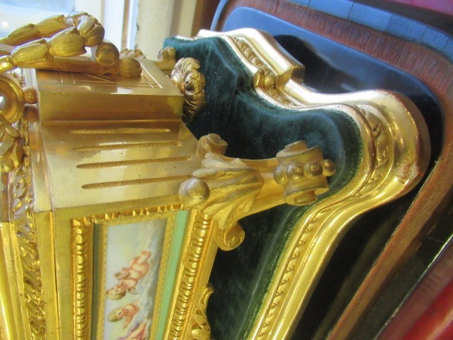 A FRENCH GILT METAL AND INSET PORCELAIN CLOCK GARNITURE Image