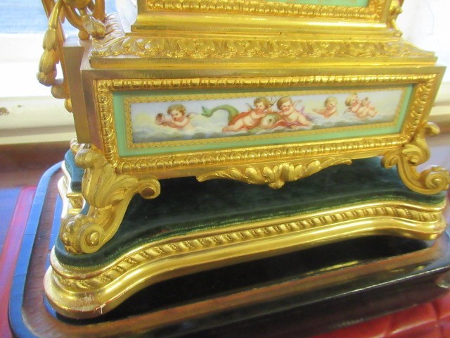 A FRENCH GILT METAL AND INSET PORCELAIN CLOCK GARNITURE Image