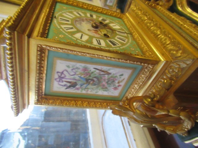 A FRENCH GILT METAL AND INSET PORCELAIN CLOCK GARNITURE Image