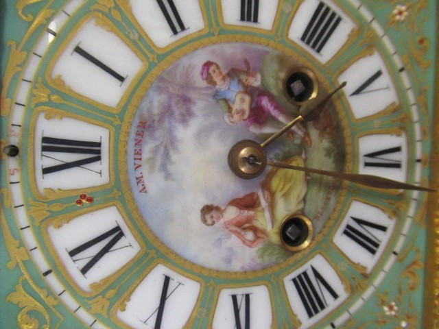 A FRENCH GILT METAL AND INSET PORCELAIN CLOCK GARNITURE Image