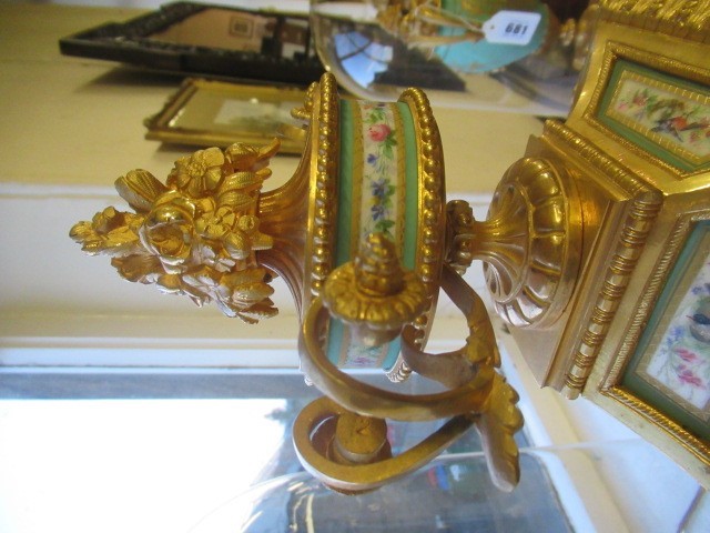 A FRENCH GILT METAL AND INSET PORCELAIN CLOCK GARNITURE Image