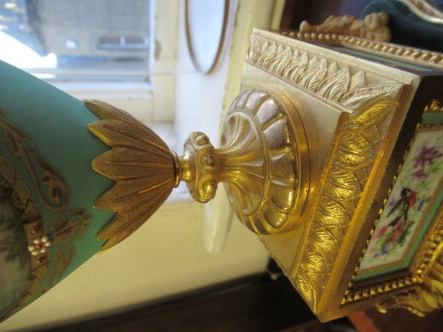 A FRENCH GILT METAL AND INSET PORCELAIN CLOCK GARNITURE Image