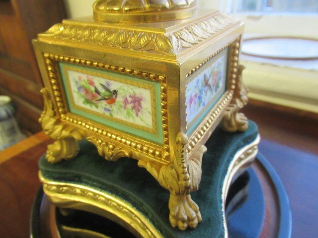 A FRENCH GILT METAL AND INSET PORCELAIN CLOCK GARNITURE Image
