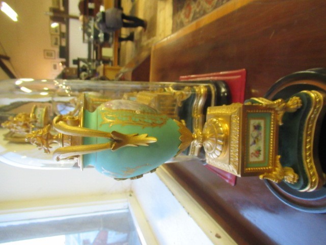 A FRENCH GILT METAL AND INSET PORCELAIN CLOCK GARNITURE Image