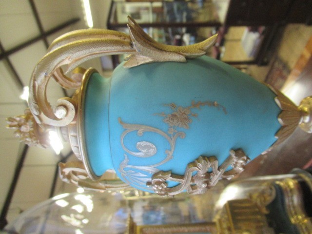 A FRENCH GILT METAL AND INSET PORCELAIN CLOCK GARNITURE Image