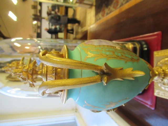 A FRENCH GILT METAL AND INSET PORCELAIN CLOCK GARNITURE Image