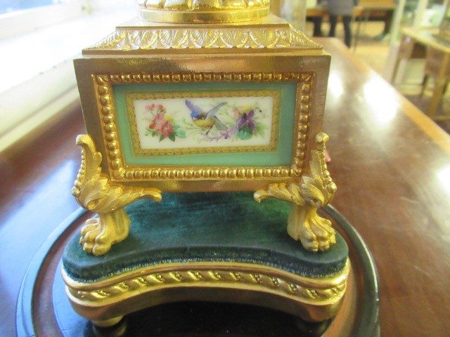 A FRENCH GILT METAL AND INSET PORCELAIN CLOCK GARNITURE Image