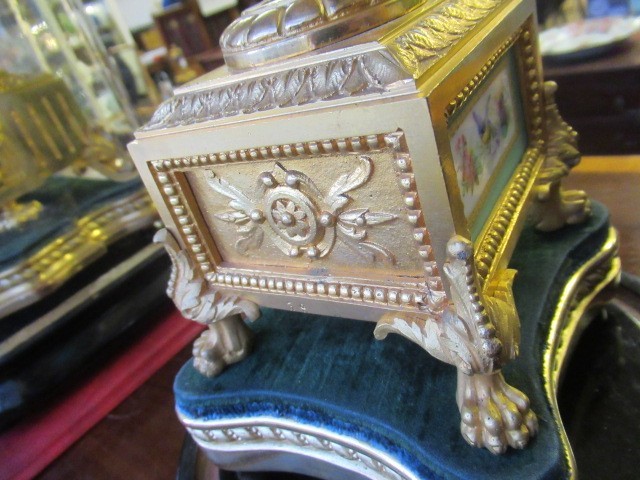 A FRENCH GILT METAL AND INSET PORCELAIN CLOCK GARNITURE Image