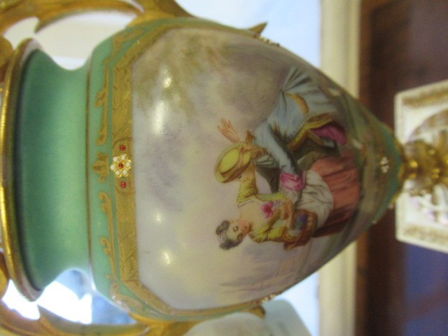 A FRENCH GILT METAL AND INSET PORCELAIN CLOCK GARNITURE Image