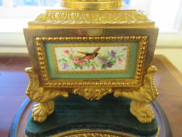 A FRENCH GILT METAL AND INSET PORCELAIN CLOCK GARNITURE Image
