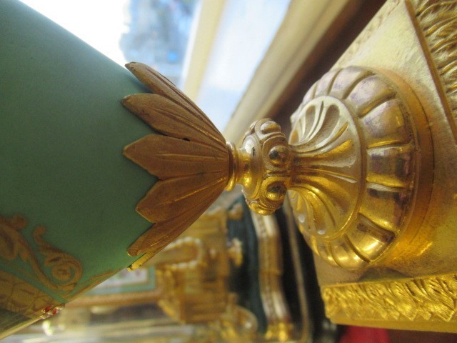 A FRENCH GILT METAL AND INSET PORCELAIN CLOCK GARNITURE Image