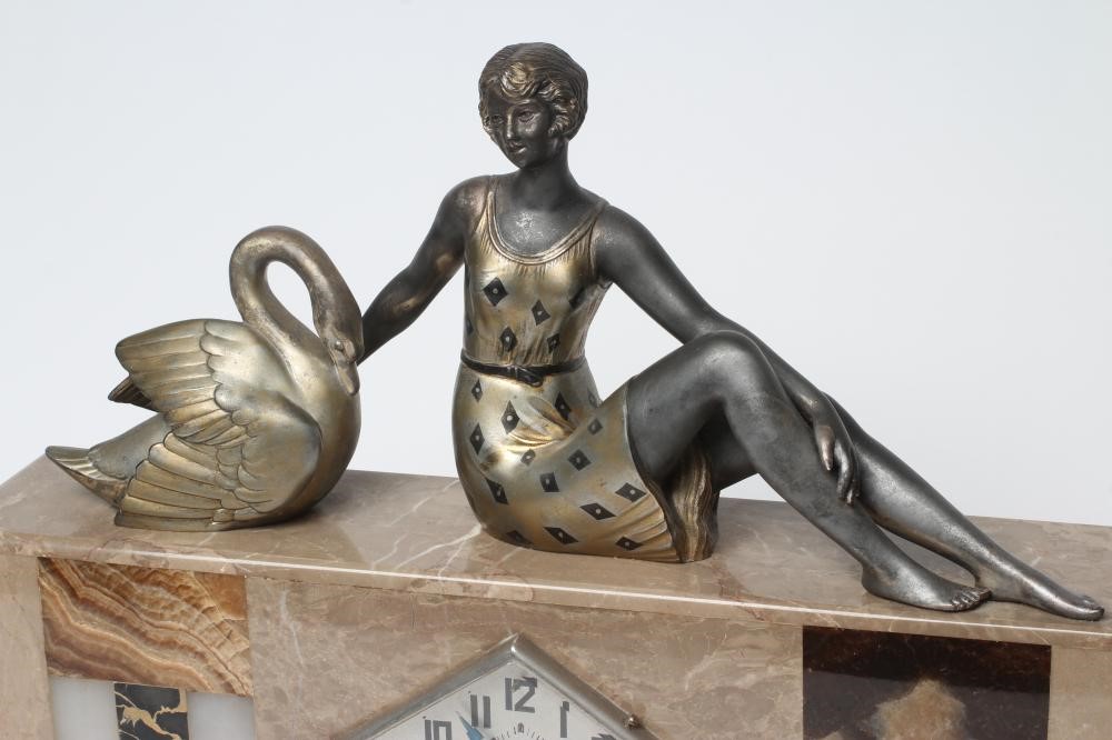 AN ART DECO ONYX AND SPELTER CLOCK GARNITURE Image