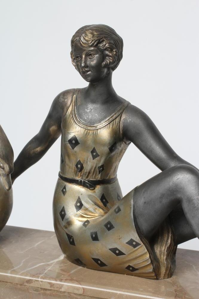 AN ART DECO ONYX AND SPELTER CLOCK GARNITURE Image