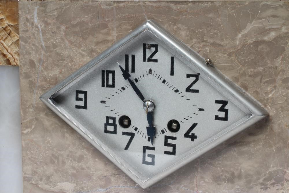 AN ART DECO ONYX AND SPELTER CLOCK GARNITURE Image
