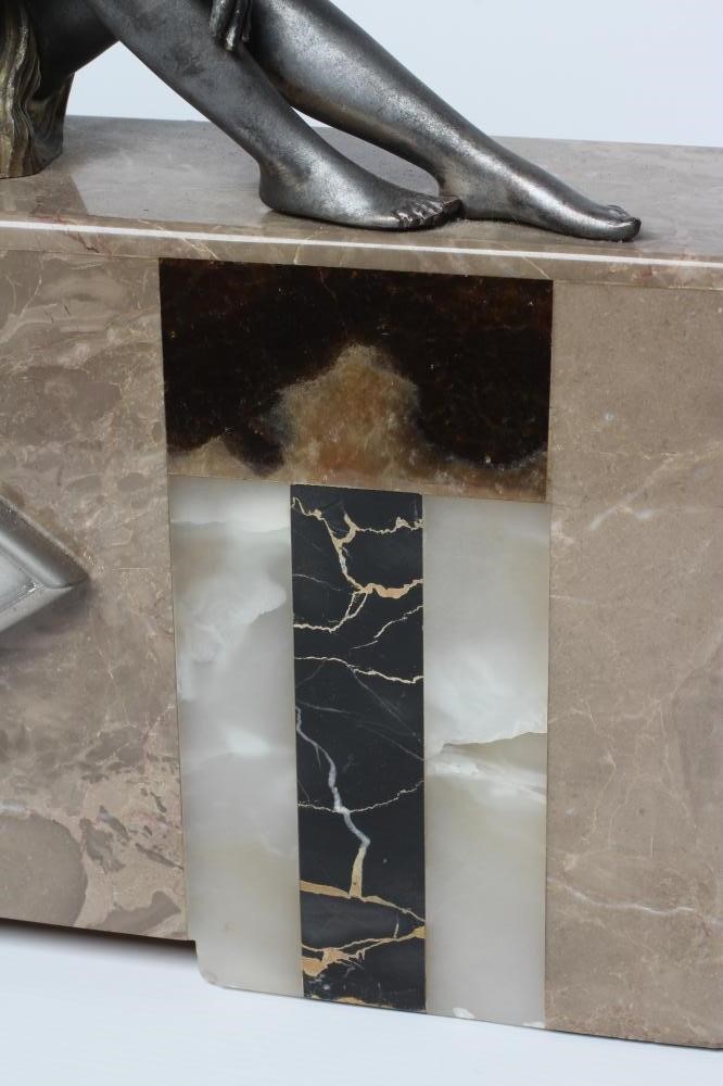 AN ART DECO ONYX AND SPELTER CLOCK GARNITURE Image