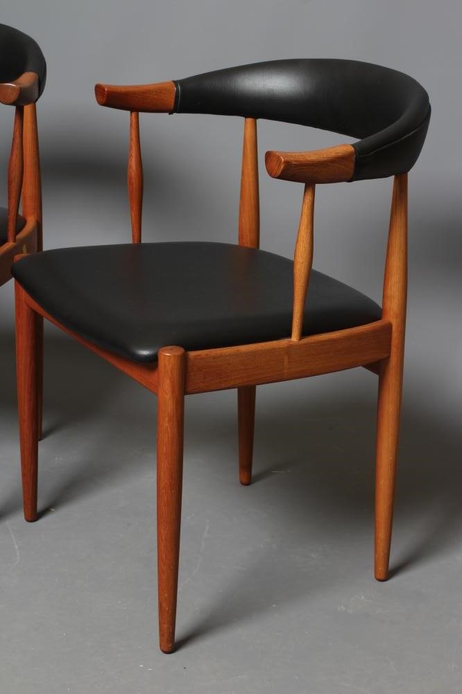 A PAIR OF TEAK ELBOW CHAIRS Image