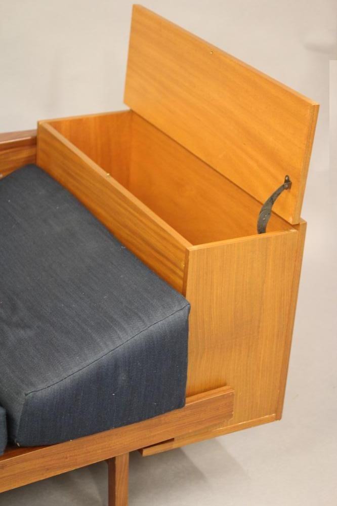 A GUY ROGERS TEAK LOUNGE SUITE comprising a pair of arm chairs button upholstered in deep blue tweed Image