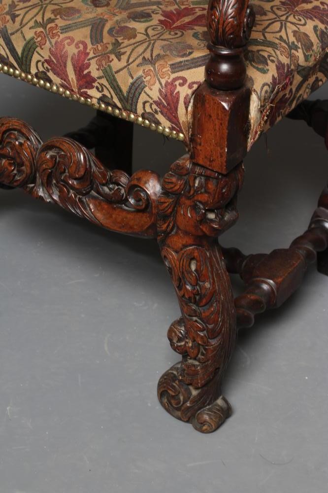 A CHARLES II CARVED WALNUT HIGH BACK ARMCHAIR Image