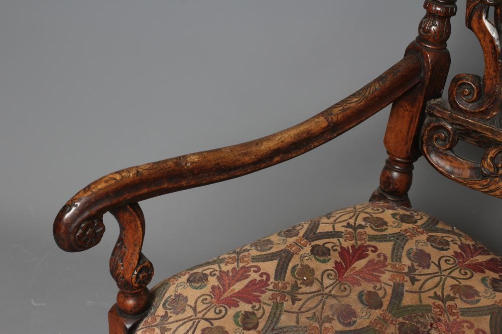 A CHARLES II CARVED WALNUT HIGH BACK ARMCHAIR Image
