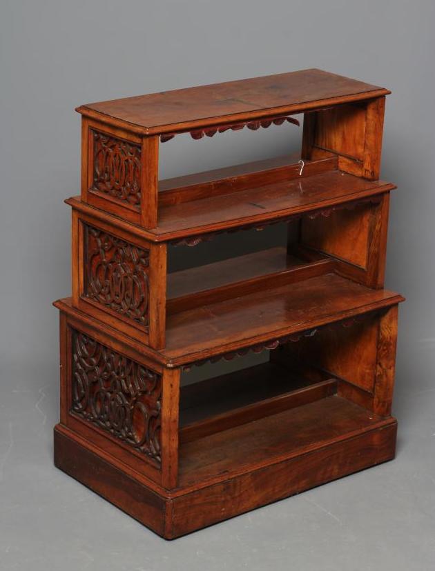 A SMALL VICTORIAN WALNUT FREE STANDING OPEN BOOKCASE of stepped rounded oblong form Image