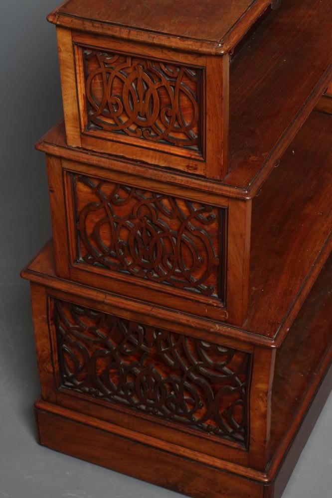 A SMALL VICTORIAN WALNUT FREE STANDING OPEN BOOKCASE of stepped rounded oblong form Image