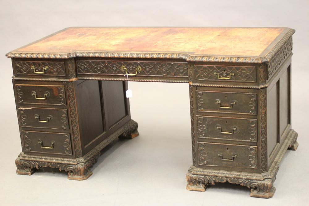 A VICTORIAN CARVED OAK PEDESTAL DESK Image