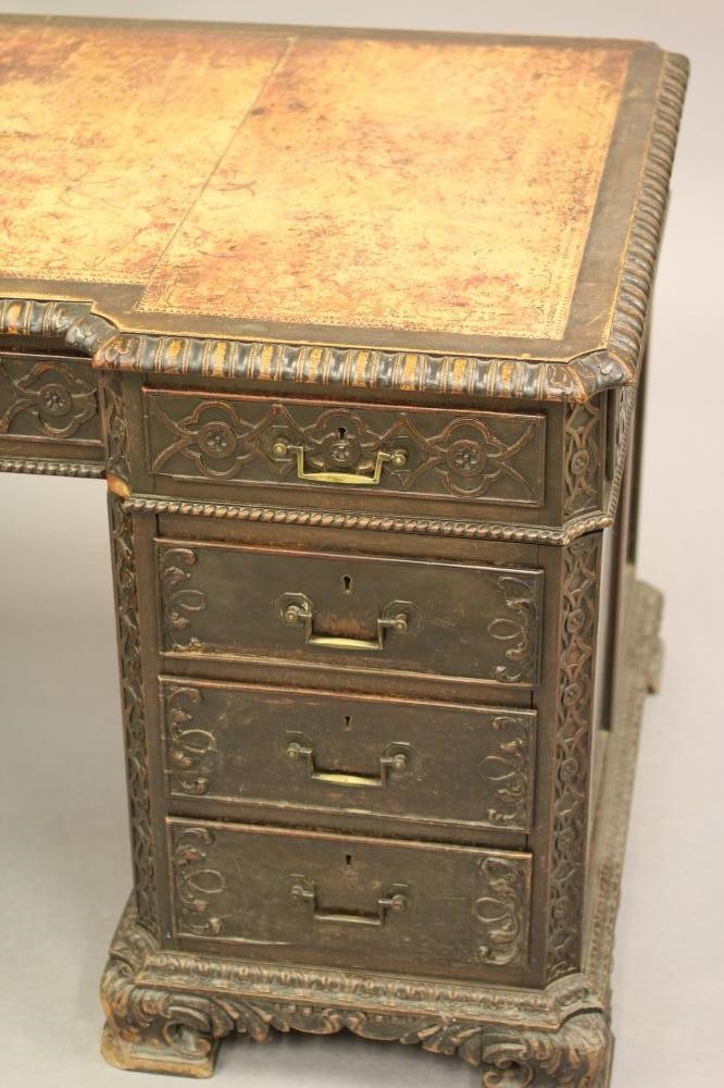 A VICTORIAN CARVED OAK PEDESTAL DESK Image