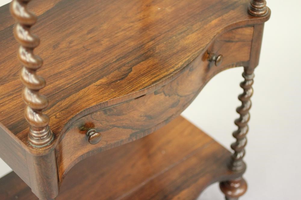 A VICTORIAN ROSEWOOD THREE TIER WHATNOT of oblong serpentine form with pierced gallery Image