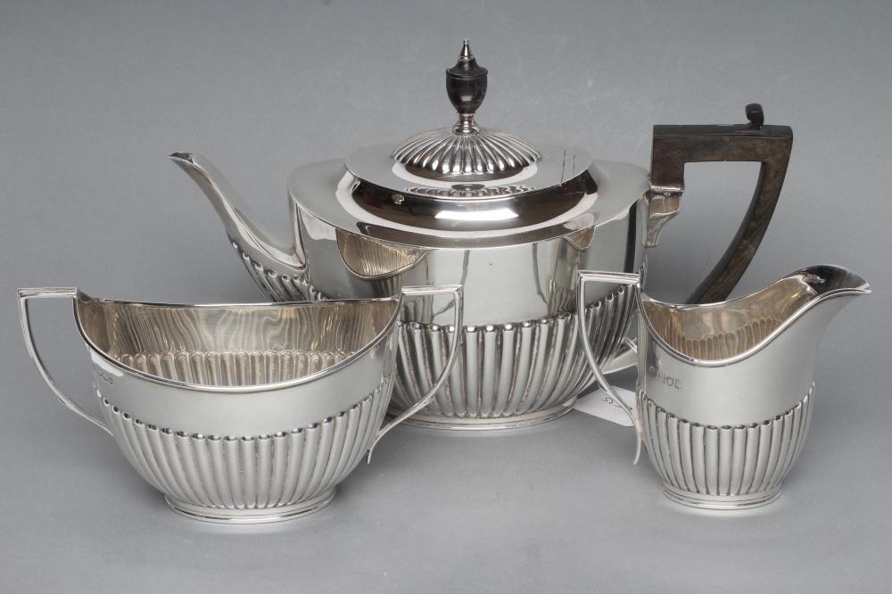 A SILVER COMPOSITE THREE PIECE TEA SERVICE Image