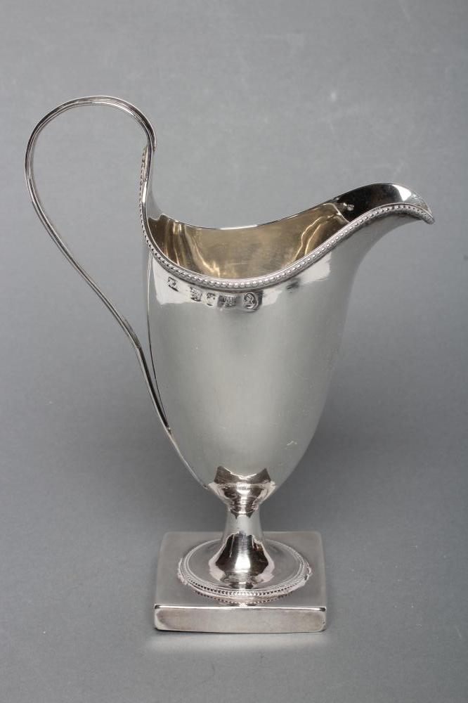 A GEORGE III SILVER HELMET MILK JUG Image
