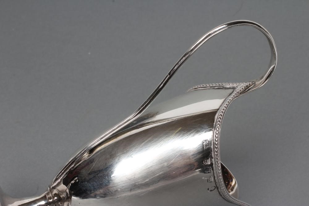 A GEORGE III SILVER HELMET MILK JUG Image