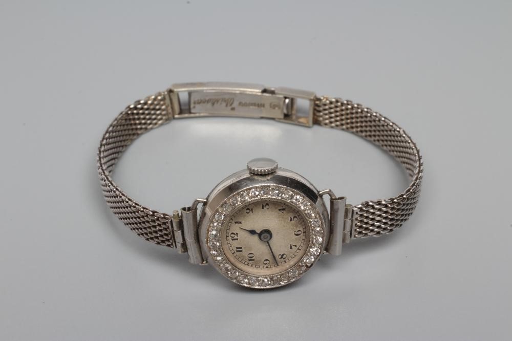 A DIAMOND AND PLATINUM COCKTAIL WATCH Image