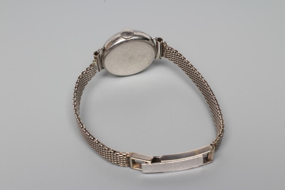 A DIAMOND AND PLATINUM COCKTAIL WATCH Image