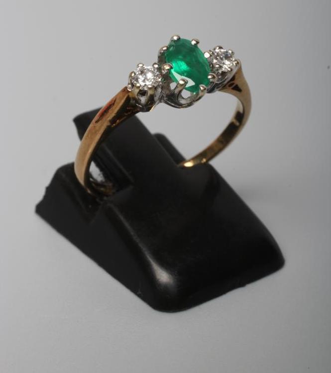A THREE STONE EMERALD AND DIAMOND RING Image