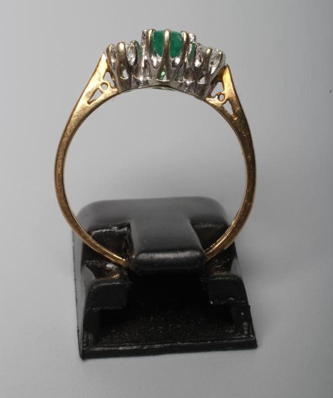 A THREE STONE EMERALD AND DIAMOND RING Image