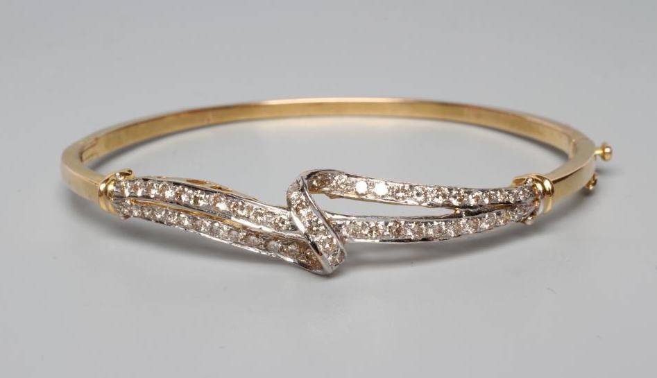 A DIAMOND STIFF HINGED BANGLE Image