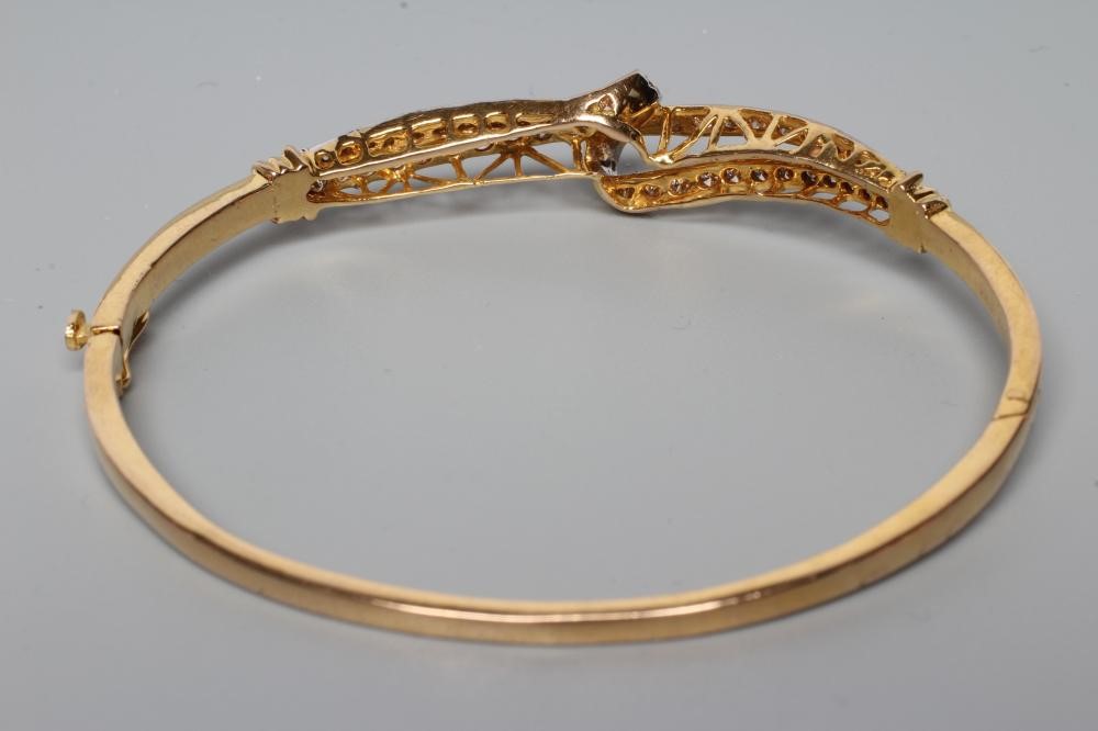 A DIAMOND STIFF HINGED BANGLE Image